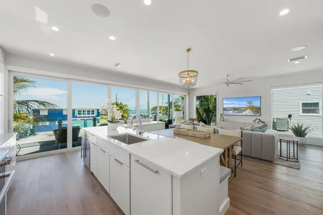a kitchen with a table chairs and wooden floor