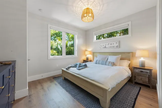 a living room with furniture and large windows