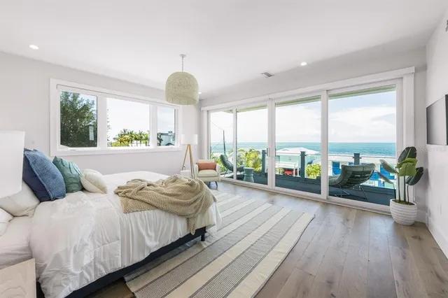 a bedroom with a bed and large window