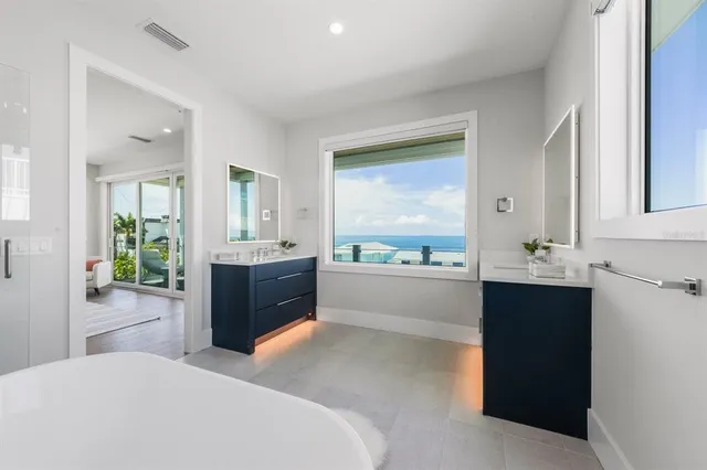 a spacious bathroom with a bathtub sink and mirror