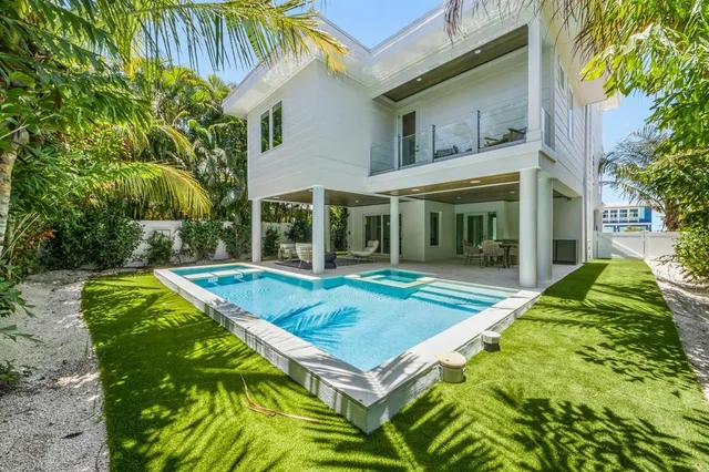 an aerial view of a houses with a yard