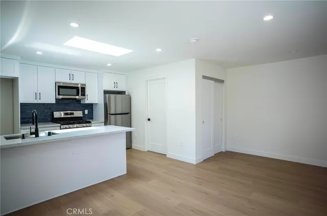 a kitchen with kitchen island a sink stainless steel appliances and cabinets