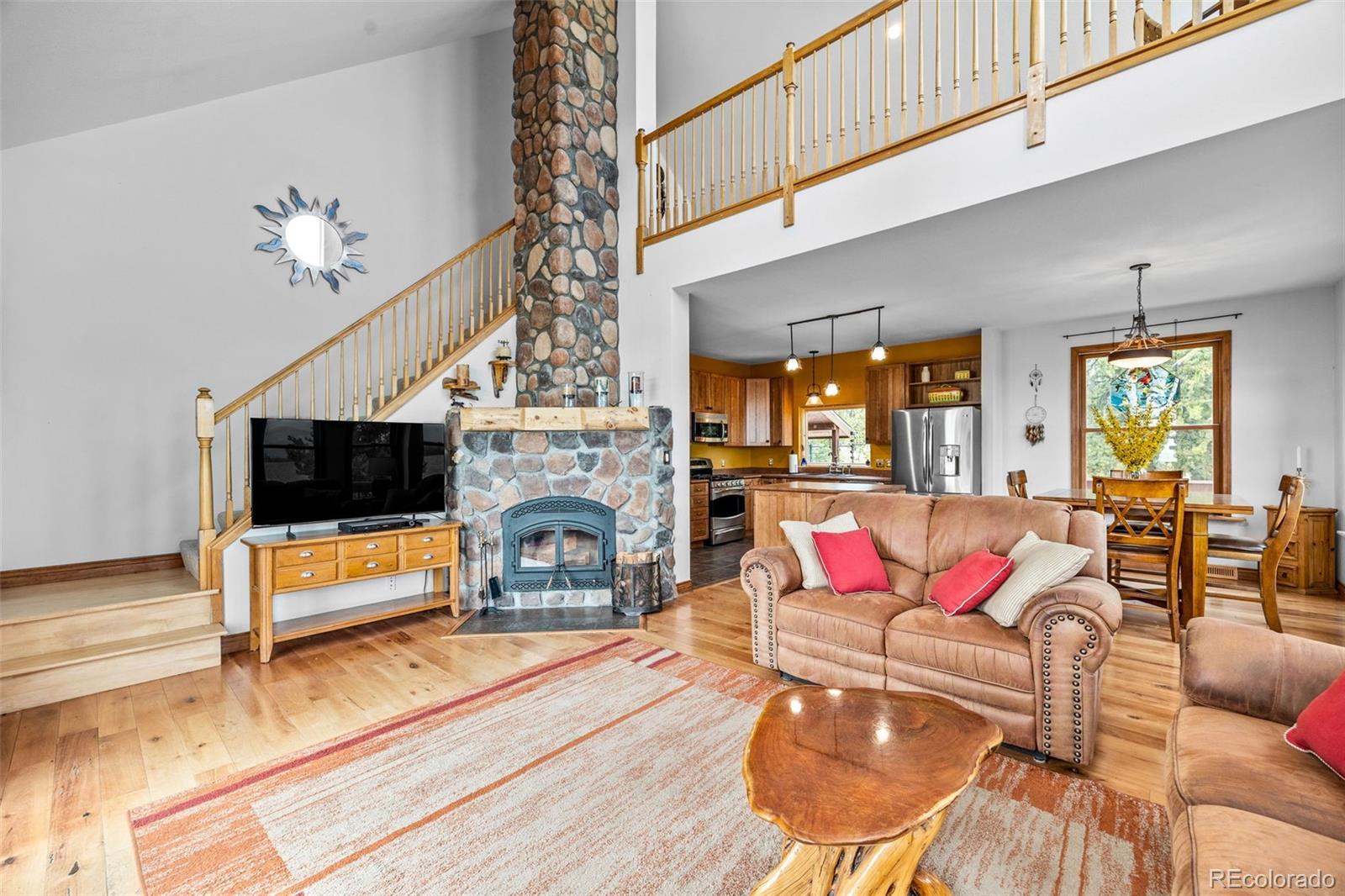 2020 Mullenville Road Fairplay, CO 80440 - Photo 14 of 49 a living room with furniture a flat screen tv and a fireplace
