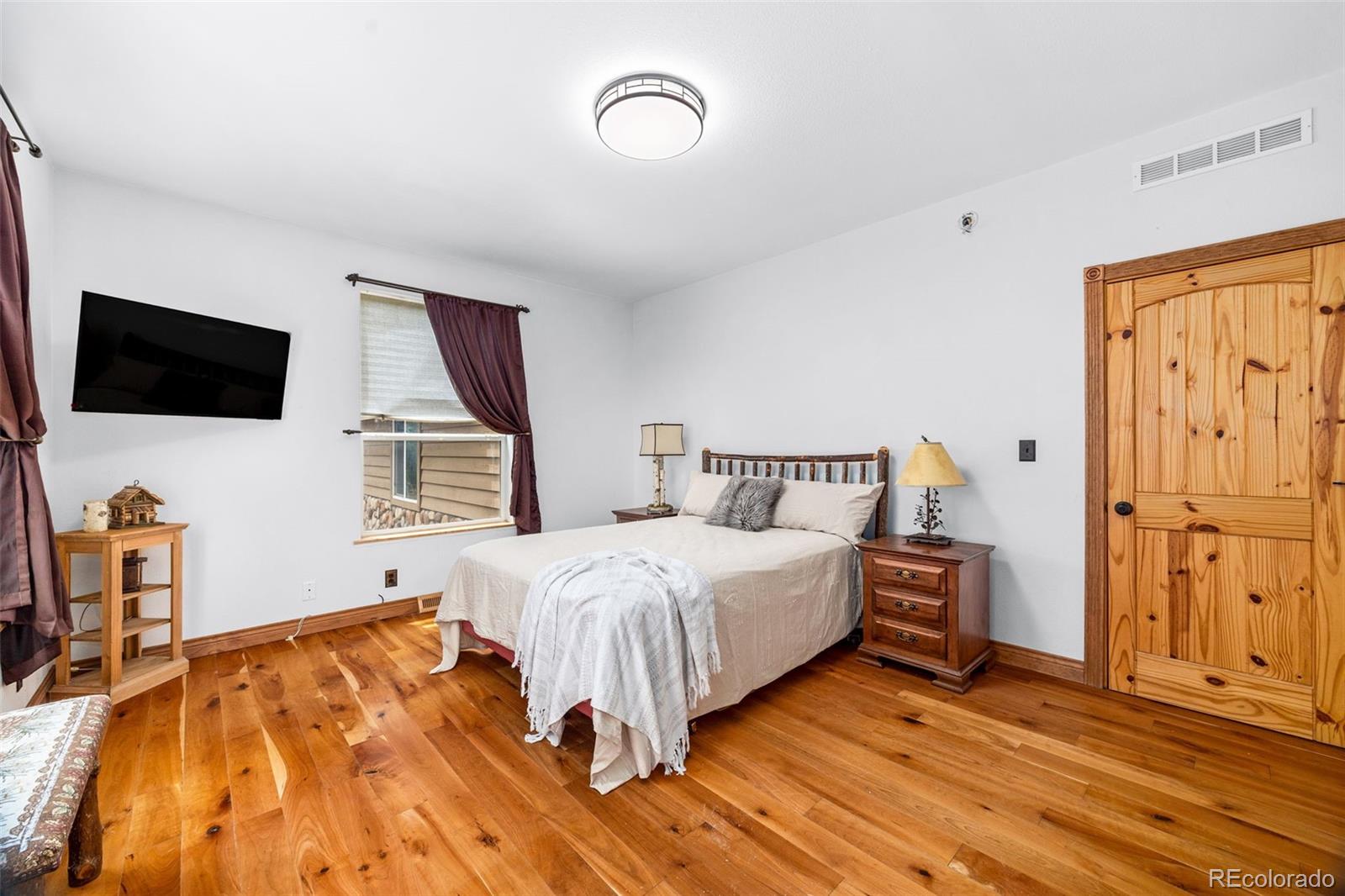 2020 Mullenville Road Fairplay, CO 80440 - Photo 24 of 49 a bedroom with a bed and a flat tv screen on dresser