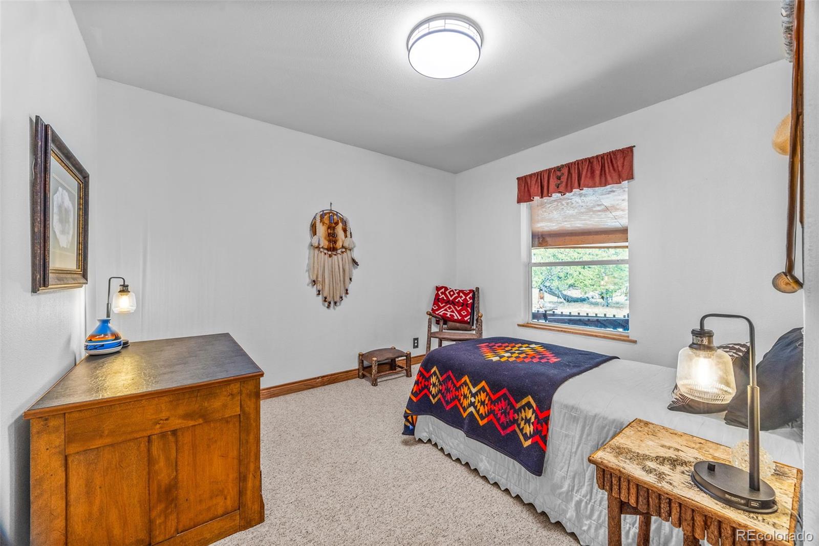 2020 Mullenville Road Fairplay, CO 80440 - Photo 26 of 49 a bedroom with furniture and a window