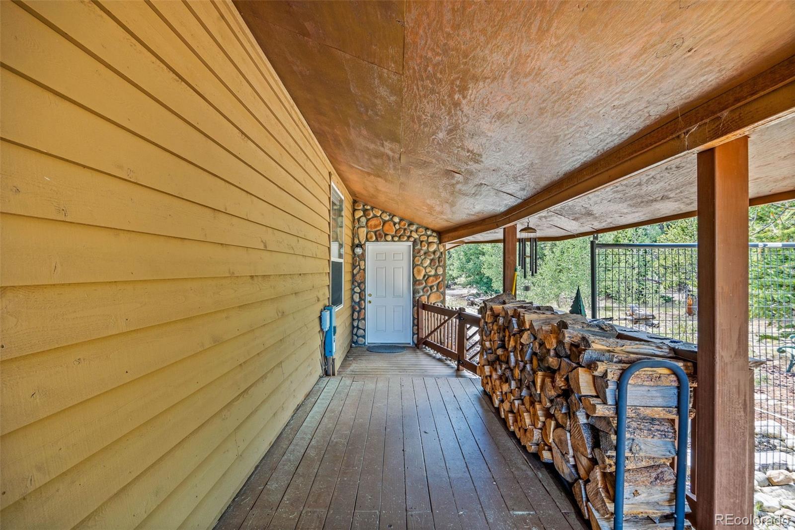 2020 Mullenville Road Fairplay, CO 80440 - Photo 8 of 49 a balcony with wooden floor and furniture