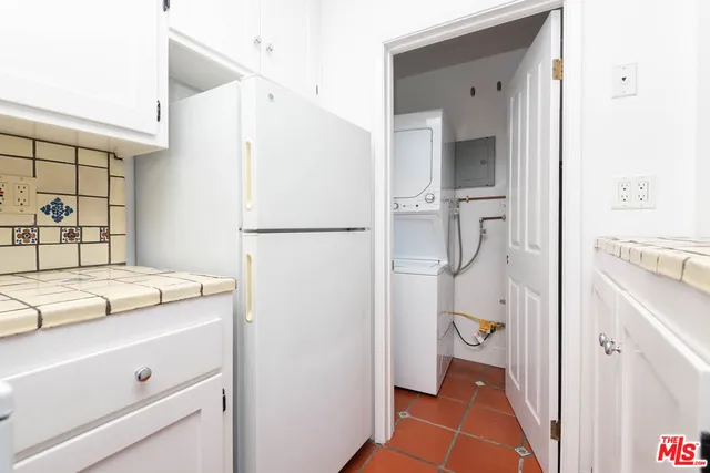 a room with a refrigerator and a sink