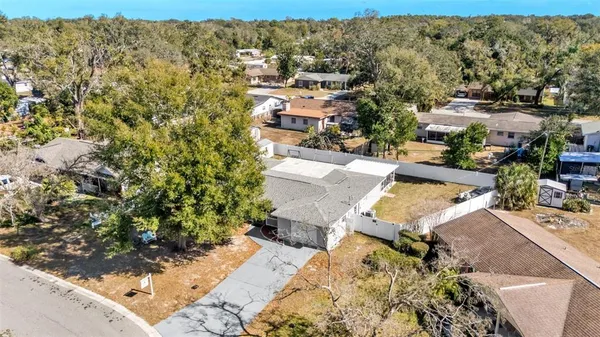 an aerial view of a house with a yard
