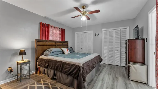 a bedroom with a bed and a refrigerator