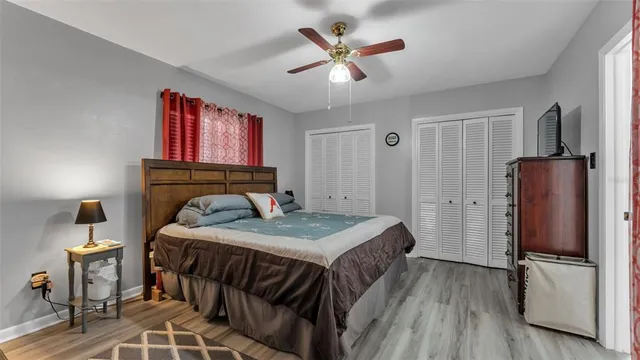 a bedroom with a bed and a refrigerator