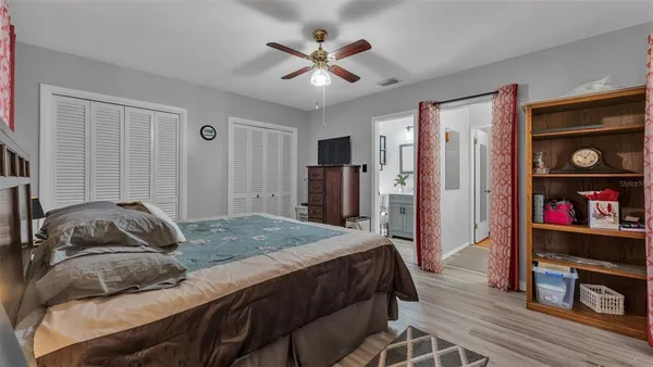 a bedroom with a bed and a book shelf