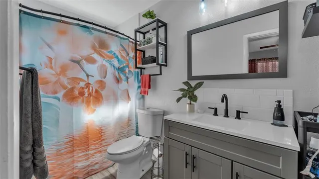 a bathroom with a sink toilet and shower