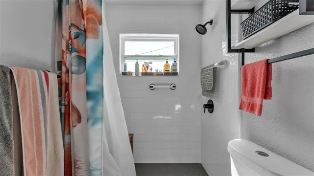 a bathroom with a shower and a toilet