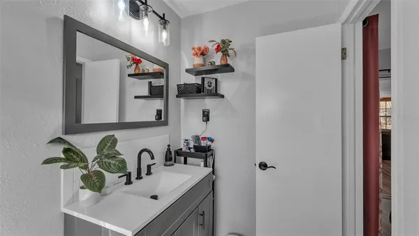a bathroom with a sink and a mirror