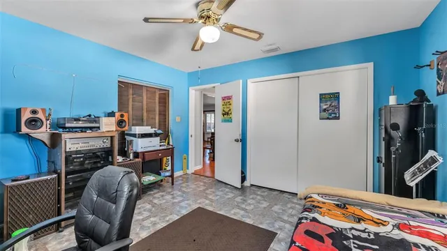 a bedroom with furniture and a flat screen tv