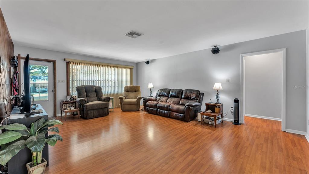 115 Morrow Circle Brandon, FL 33510 - Photo 23 of 48 a living room with furniture and a flat screen tv with wooden floor