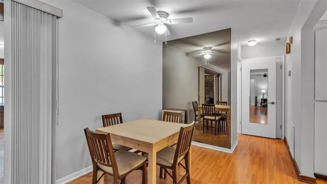 a view of a dining room with furniture and wooden floor