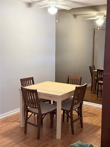 a dining room with furniture and wooden floor