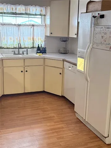 a kitchen with a sink cabinets and window