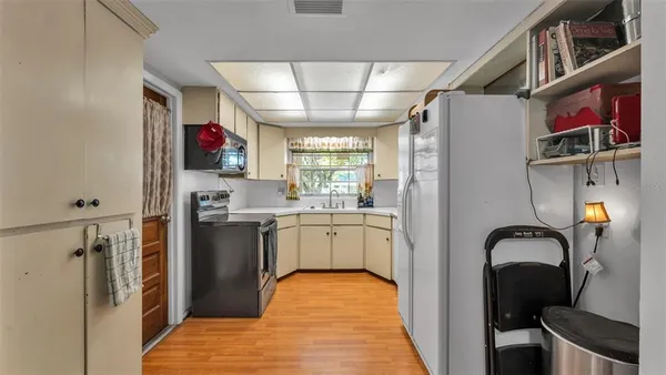 a kitchen with stainless steel appliances granite countertop a refrigerator and a sink
