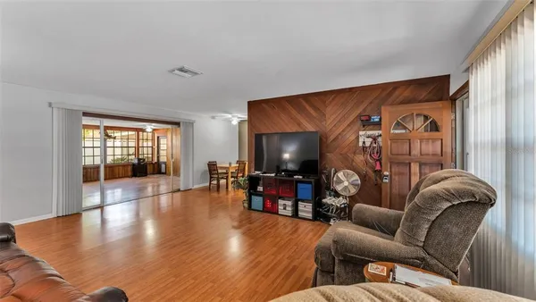 a living room with furniture and wooden floor