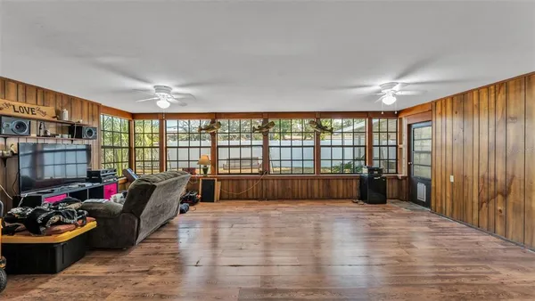 a bedroom with furniture and a large window
