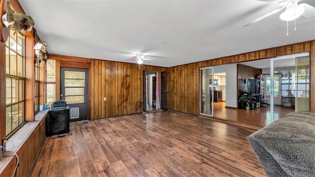 a view of empty room with wooden floor and windows