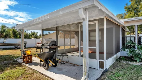 a view of a house with backyard porch and sitting area
