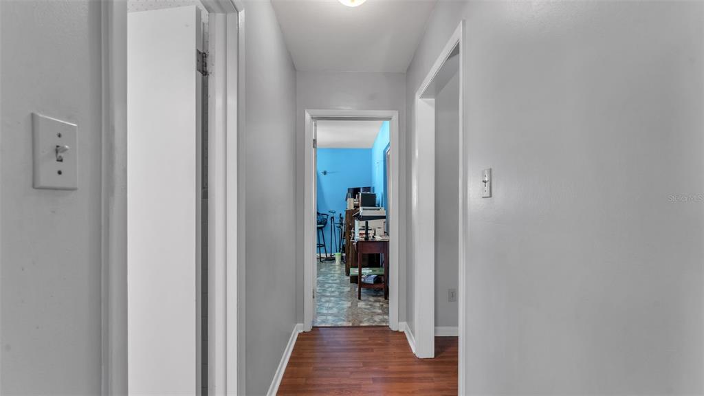 115 Morrow Circle Brandon, FL 33510 - Photo 7 of 48 a view of a hallway with wooden floor and a bathroom
