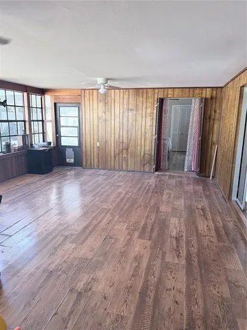 a view of wooden floor and windows in a room