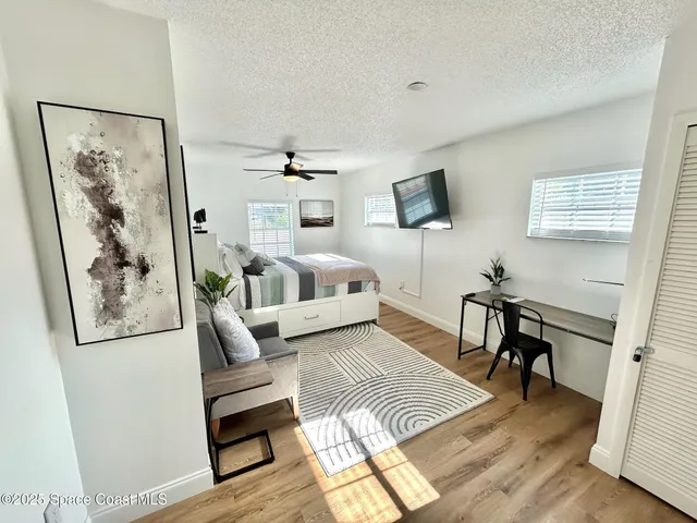 a bedroom with a bed a couch and dresser