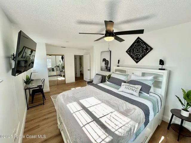 a bedroom with a bed and a flat screen tv