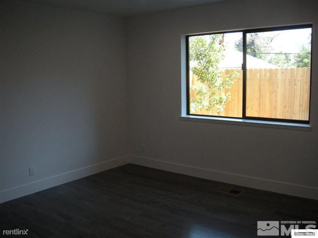 616 Thoma Street Reno, NV 89502 - Photo 8 of 11 an empty room with wooden floor and windows