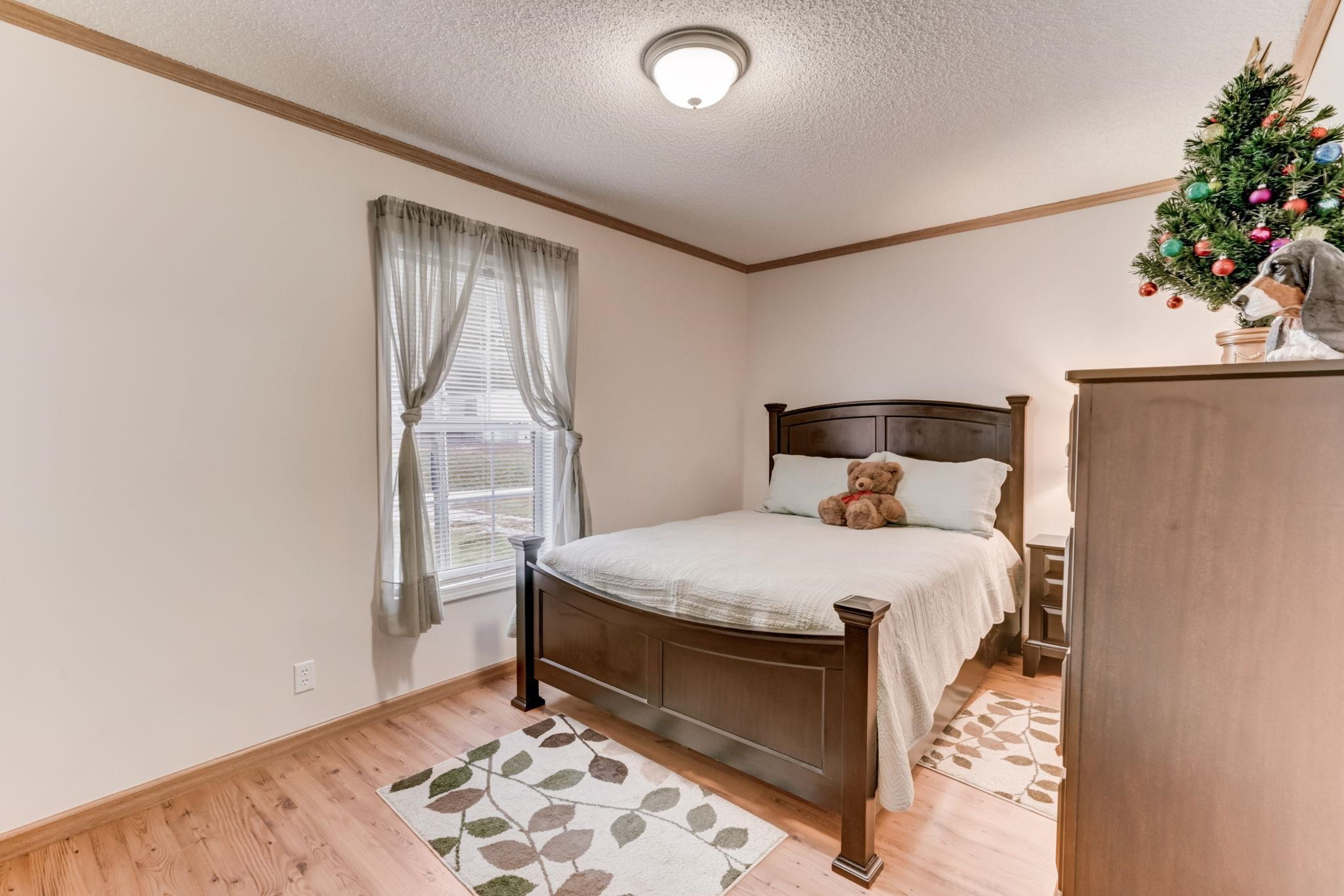 257 Marvin Gill Road Roxboro, NC 27574 - Photo 12 of 34 a bed sitting in a bedroom next to a window