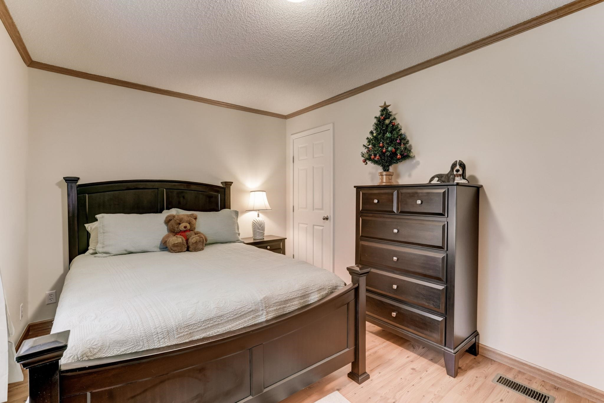 257 Marvin Gill Road Roxboro, NC 27574 - Photo 13 of 34 a bedroom with a bed and a chandelier