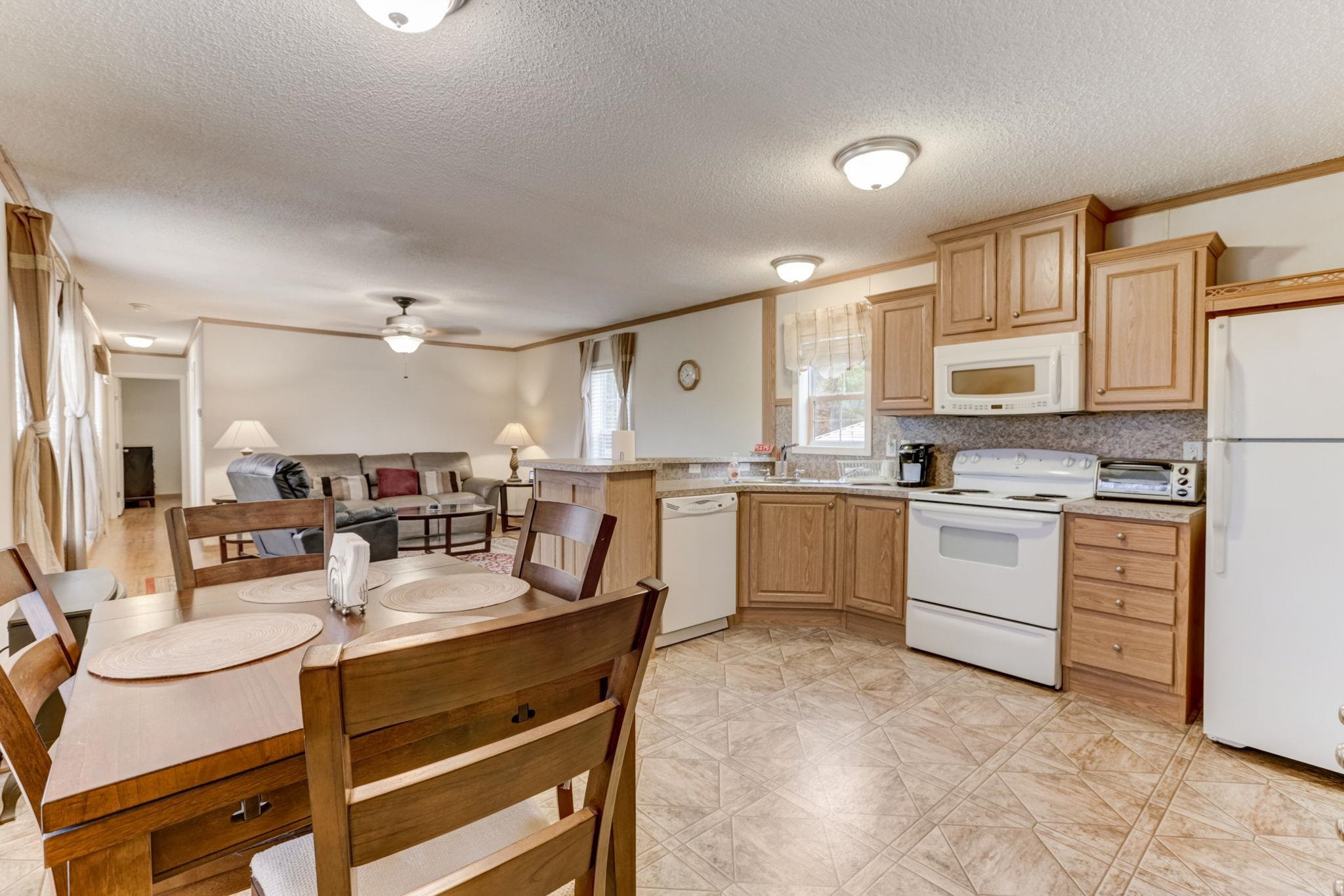 257 Marvin Gill Road Roxboro, NC 27574 - Photo 2 of 34 a kitchen with white cabinets and stainless steel appliances