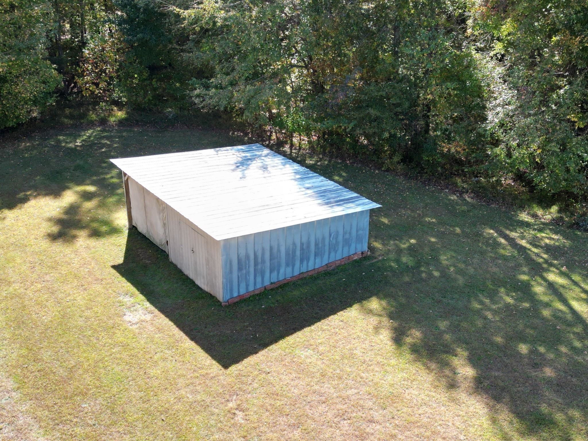 257 Marvin Gill Road Roxboro, NC 27574 - Photo 31 of 34 a view of a backyard with a small cabin