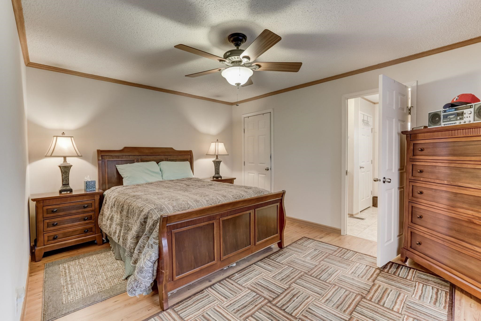 257 Marvin Gill Road Roxboro, NC 27574 - Photo 7 of 34 a bedroom with a bed and a chandelier