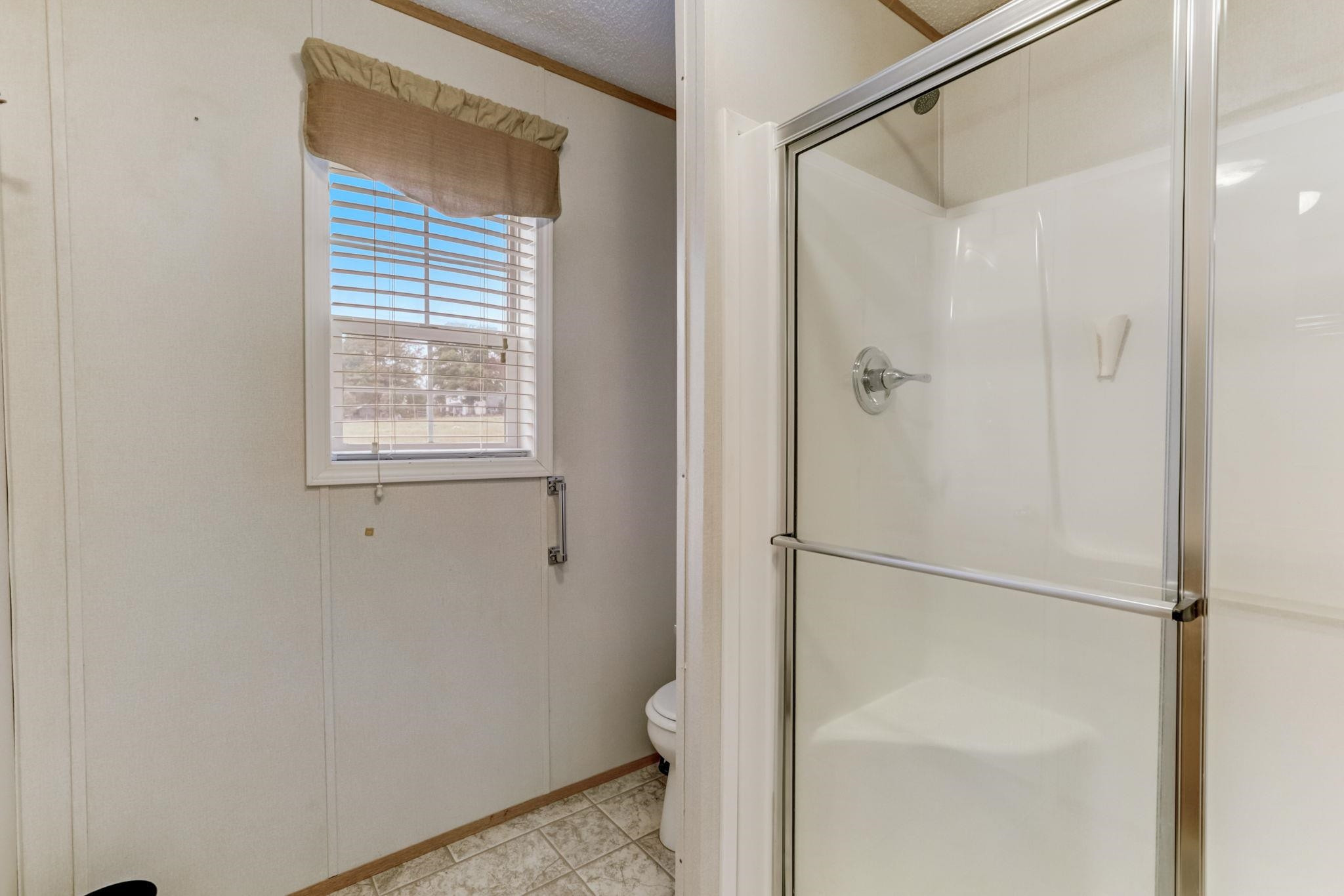 257 Marvin Gill Road Roxboro, NC 27574 - Photo 10 of 34 a bathroom with a glass shower door