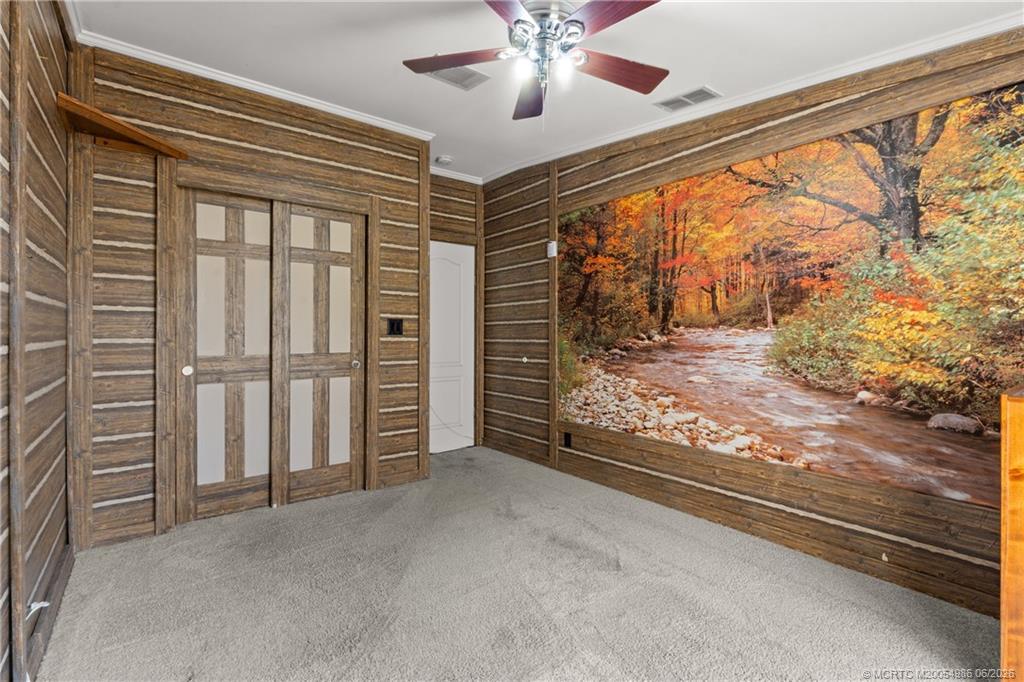 4237 4th Court Lantana, FL 33462 - Photo 18 of 40 a view of empty room with wooden floor and fan