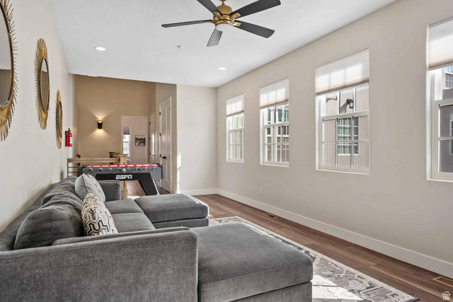 4311 Canterbury Road, Unit F2 Hurricane, UT 84737 - Photo 10 of 18 Spacious room featuring multiple windows with blinds, recessed lighting, wood-finish flooring, and a ceiling fan with brass accents