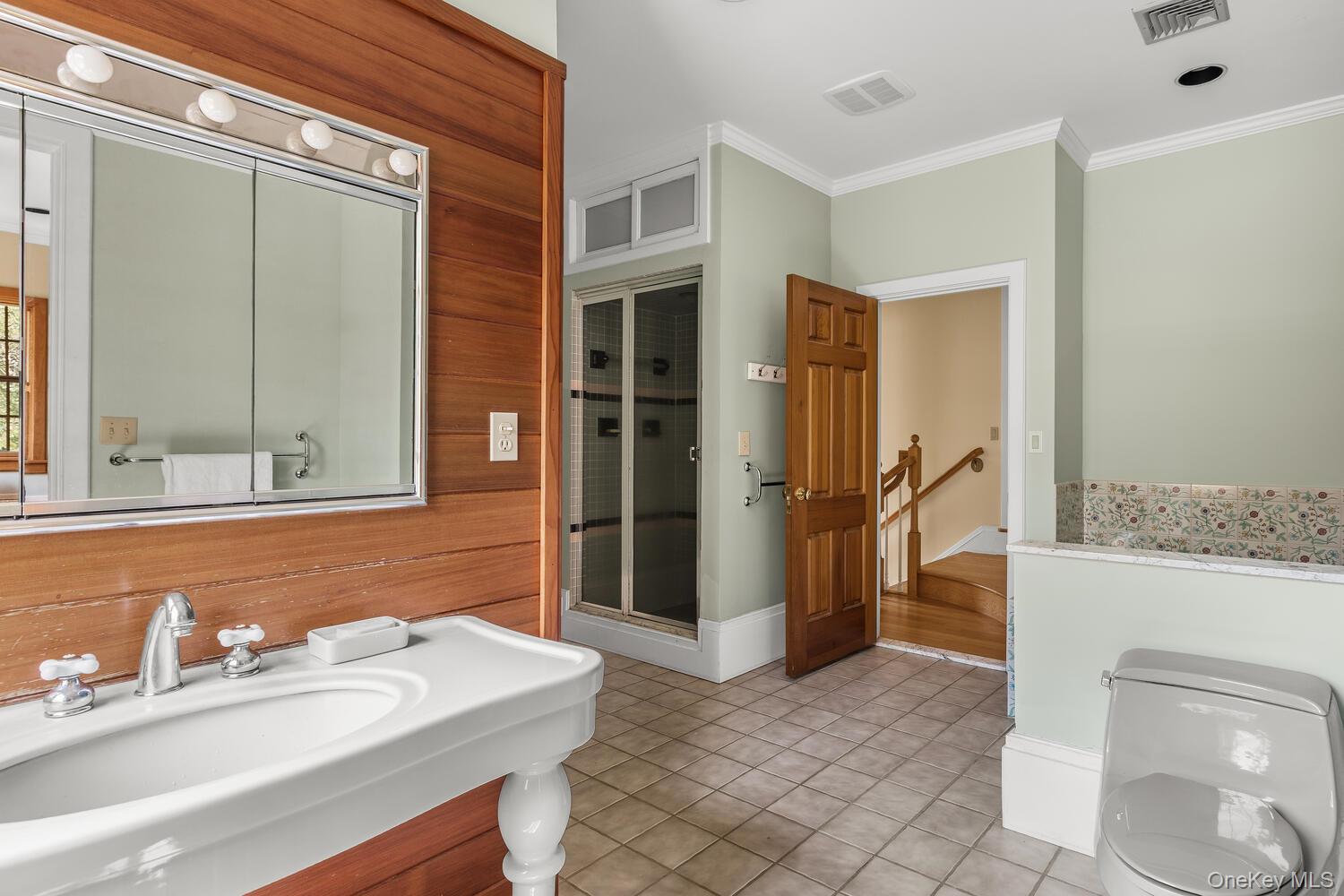 81 Glendale Road Ossining, NY 10562 - Photo 17 of 37 Full bath featuring , light tile patterned floors, a shower stall, wood walls, and vanity