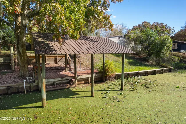 a view of a patio with table and chairs under an umbrella