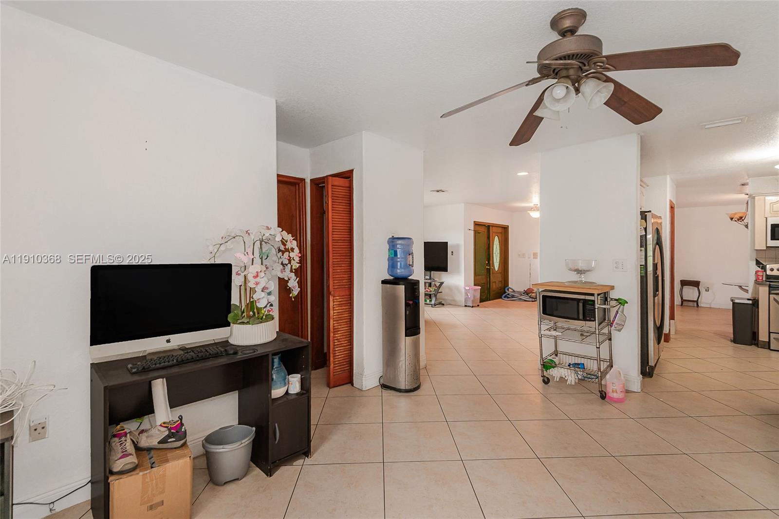 18890 Southwest 184th Street Miami, FL 33187 - Photo 18 of 37 a living room with furniture and a flat screen tv