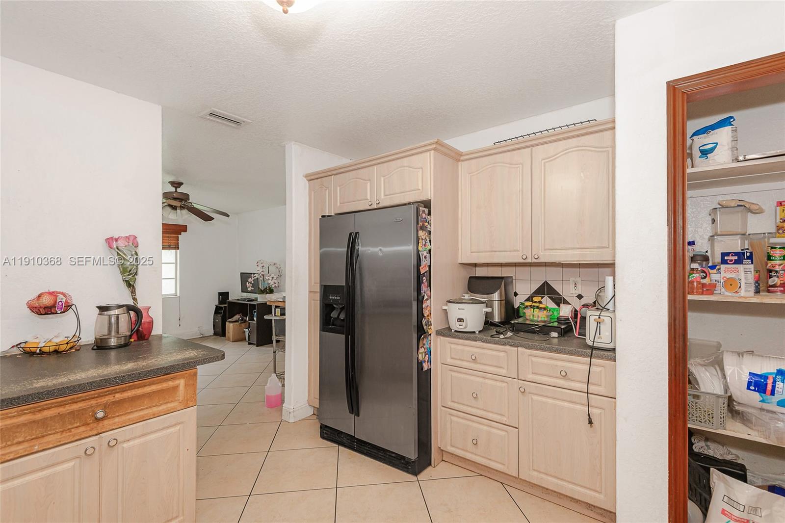 18890 Southwest 184th Street Miami, FL 33187 - Photo 19 of 37 a kitchen with stainless steel appliances a refrigerator sink and cabinets