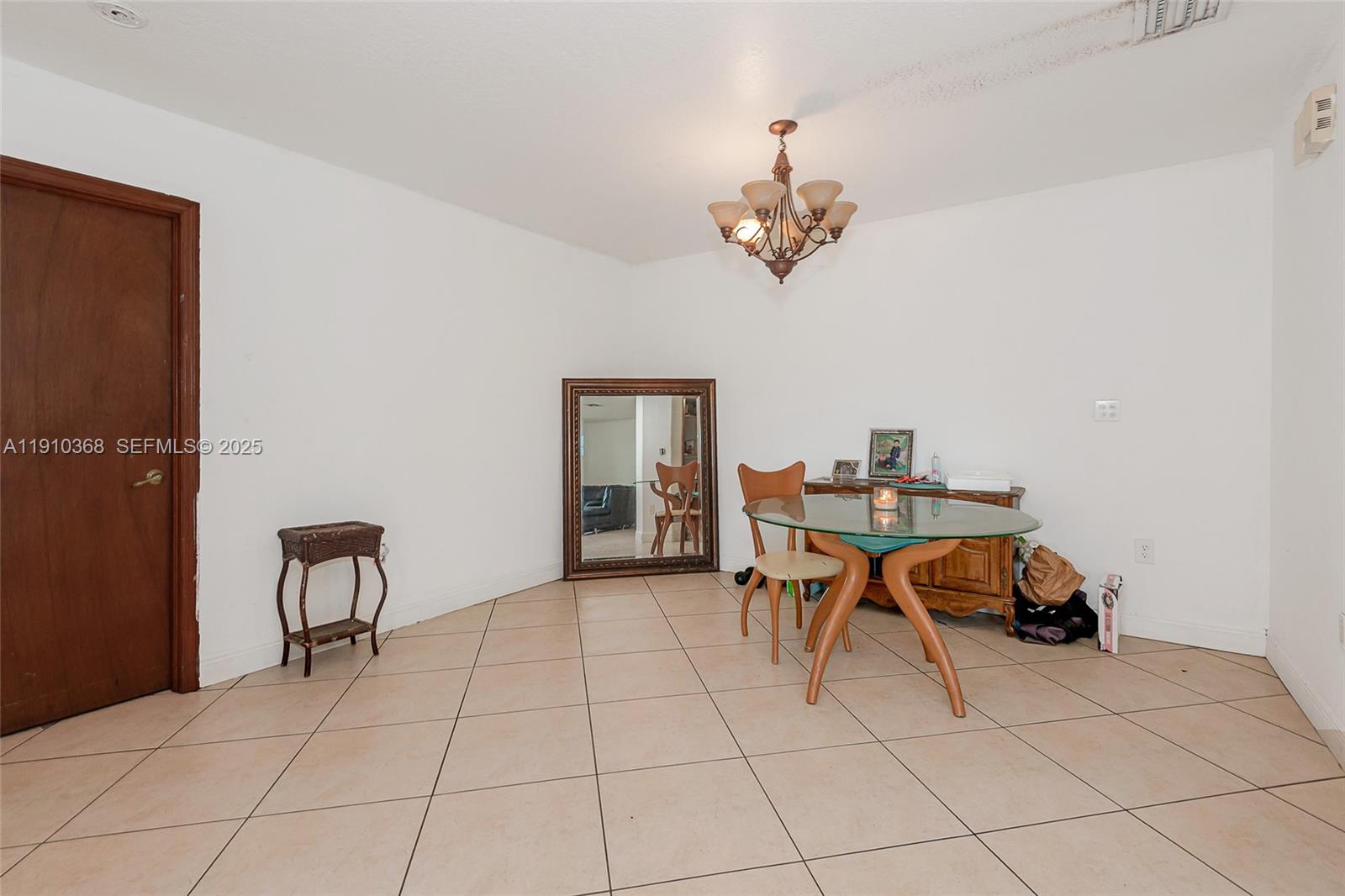 18890 Southwest 184th Street Miami, FL 33187 - Photo 20 of 37 a dining room with furniture and chandelier