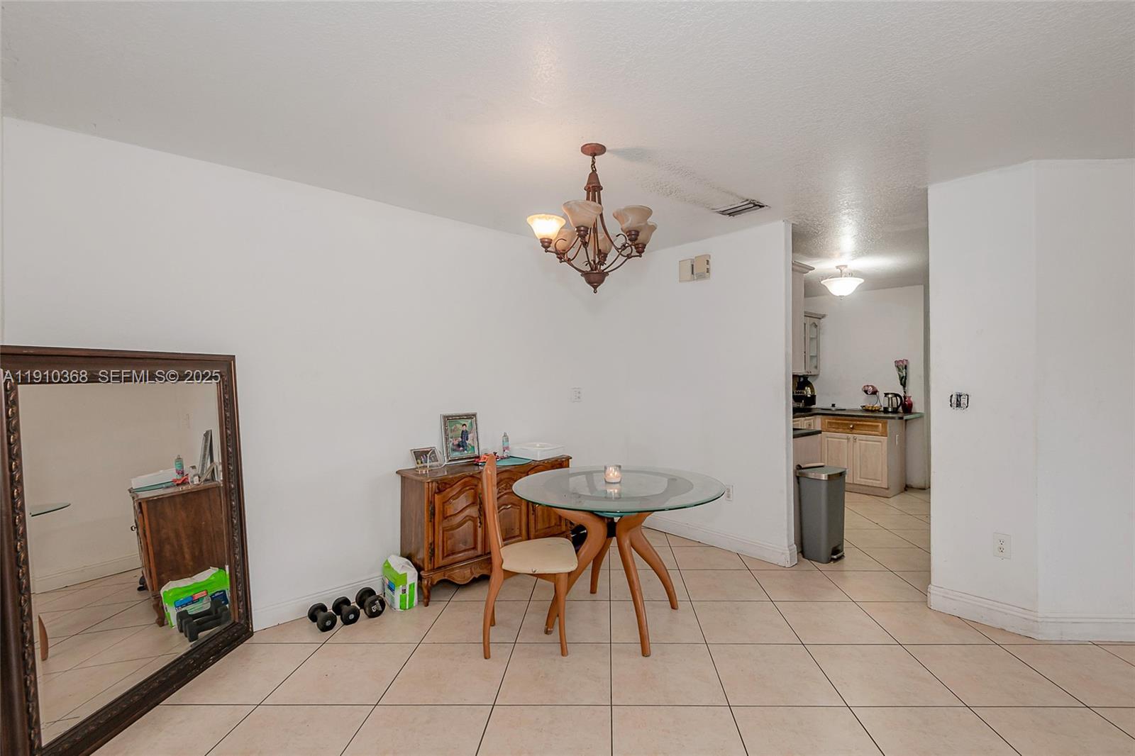 18890 Southwest 184th Street Miami, FL 33187 - Photo 21 of 37 a view of a dining room with furniture and a chandelier
