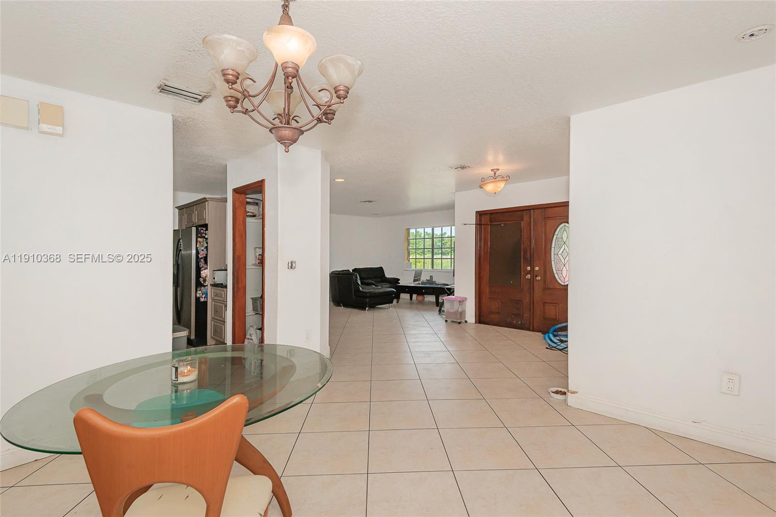 18890 Southwest 184th Street Miami, FL 33187 - Photo 22 of 37 a view of a living room and chandelier