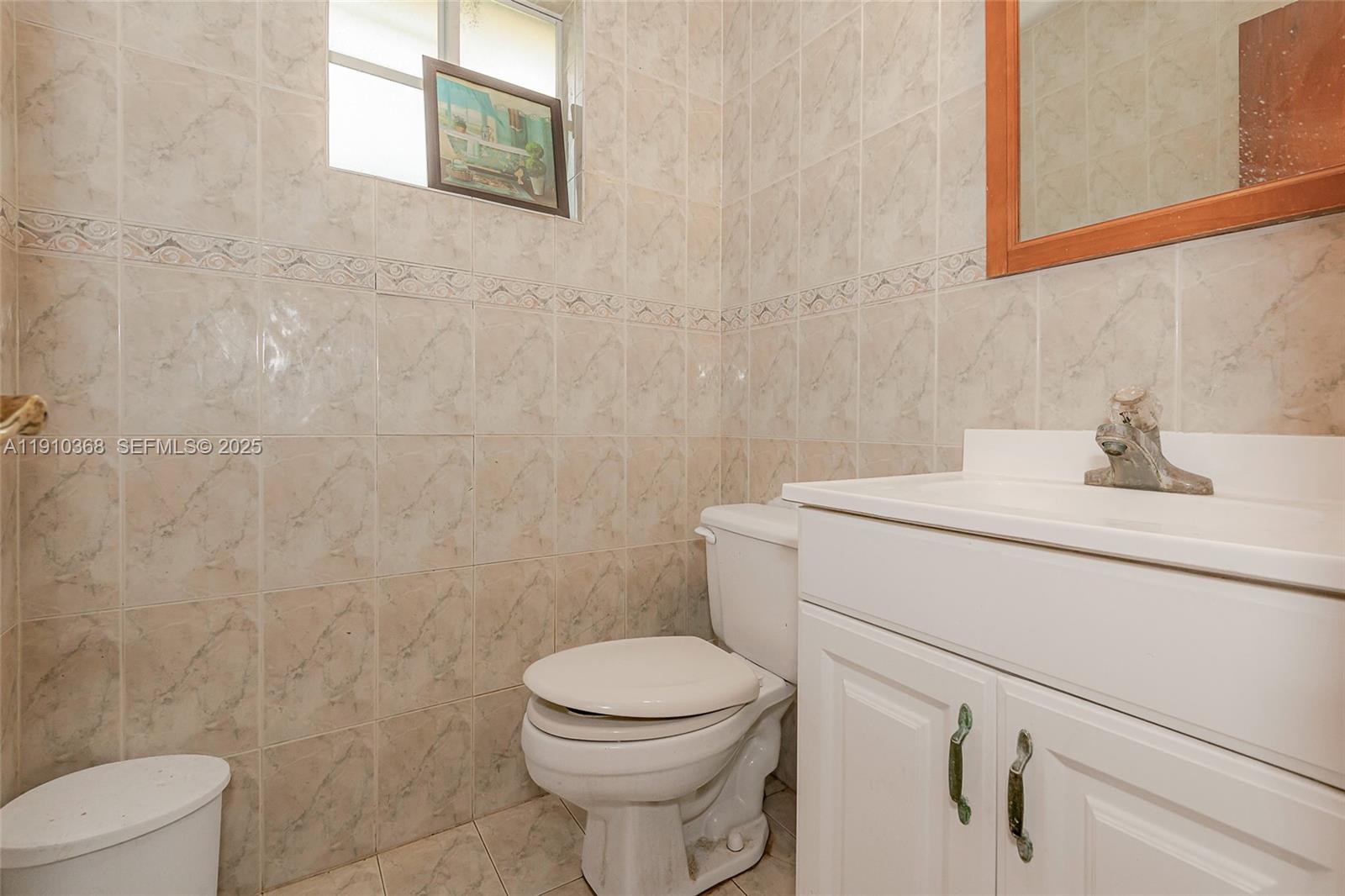 18890 Southwest 184th Street Miami, FL 33187 - Photo 24 of 37 a bathroom with a sink a toilet and a mirror