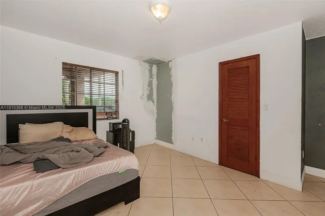 a bedroom with a bed and cabinets